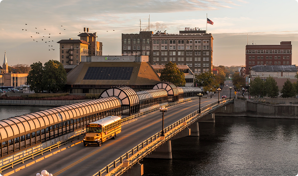 WATERLOO, IOWA - FALL 2021 - A High Angle Shot of the W 4th St Bridge over the Cedar River in Waterloo, Iowa during a Fall Sunrise