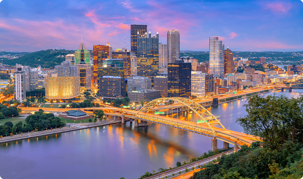 Pittsburgh, Pennsylvania, USA city skyline at dusk with bridge crossing river