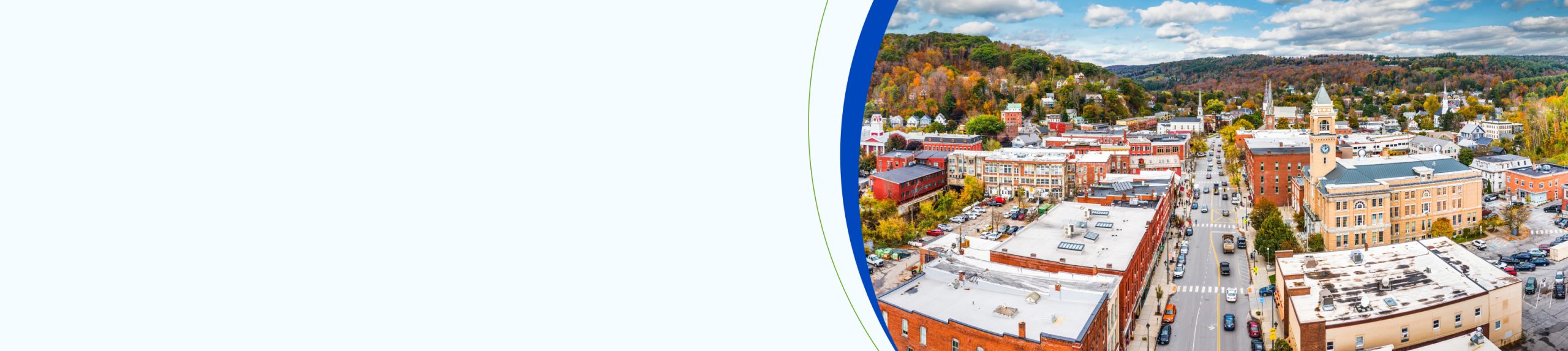 Aerial view of Montpelier, VT cityscape along Main Street on a sunny day with fall foliage colors