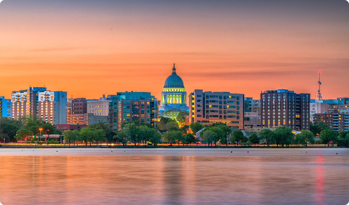 Madison, Wisconsin, USA downtown skyline at dusk on Lake Monona.